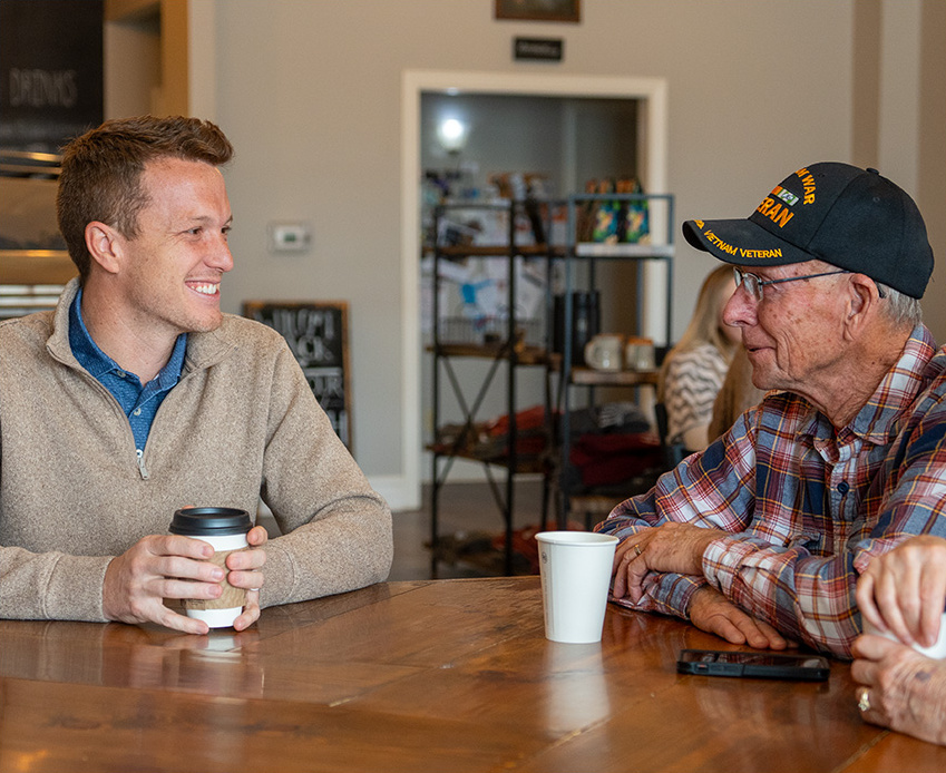 Blake Fiechter speaking to a veteran